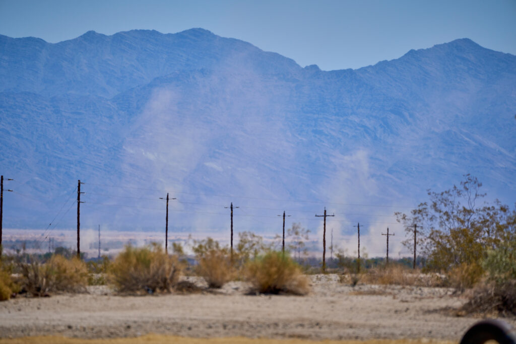 Plumes of dust rise into the sky after being kicked up by construction on solar farms near Desert Center, California, on Monday, May 8, 2023. Credit: Alex Gould
