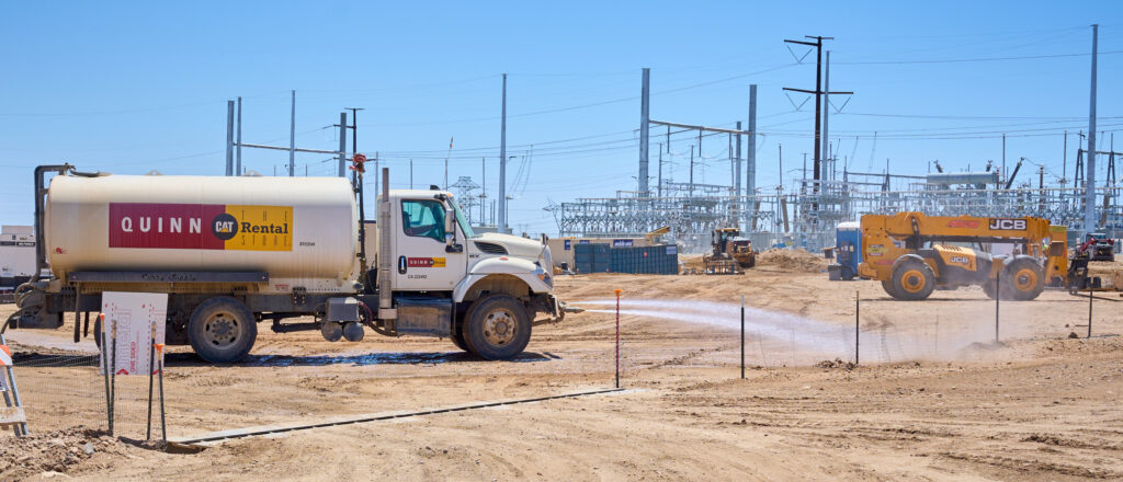 Construction crews use water tanker trucks to spray the dirt to mitigate dust kicked up by the construction of new solar developments near Desert Center, California, on Monday, May 8, 2023. Credit: Alex Gould 