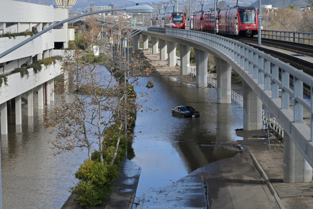 The area below the Fashion Valley Trolley Station is left flooded in the aftermath of a storm on Jan. 23 in San Diego. Credit: Carlos Moreno/Anadolu via Getty Images