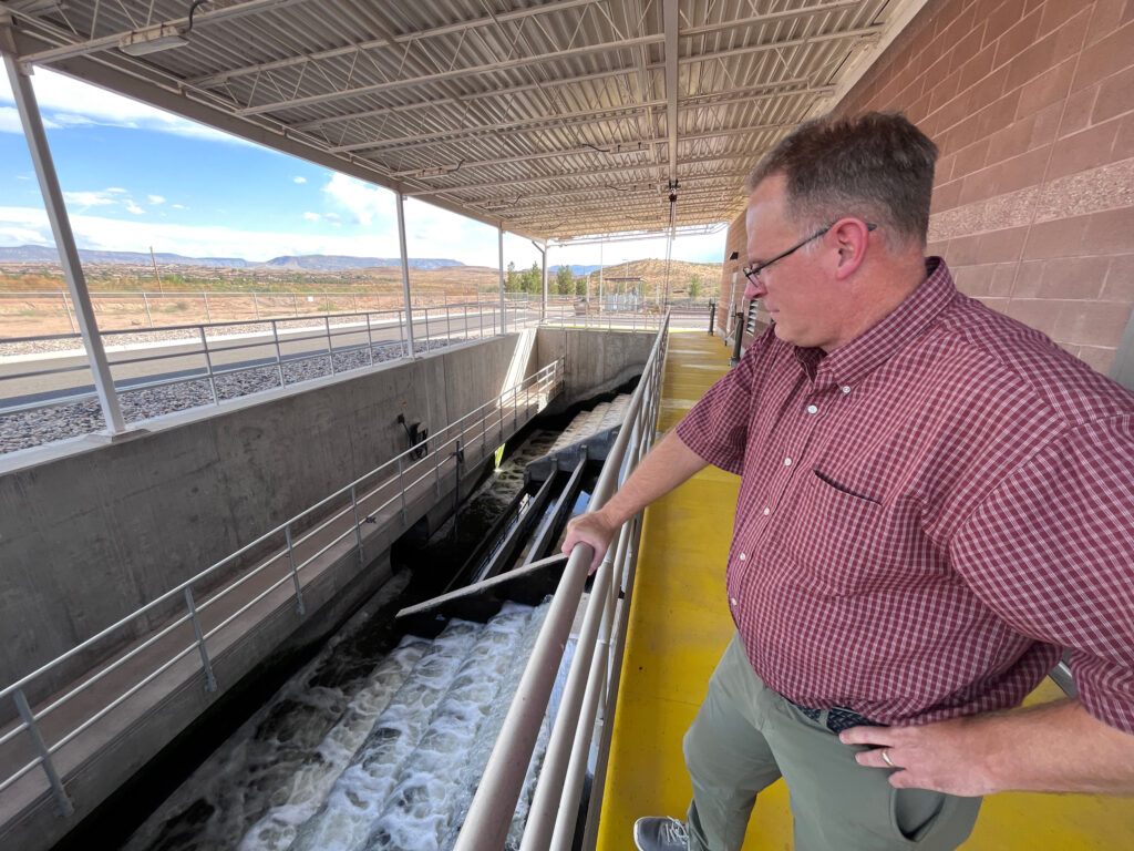 St. George Water Services Director Scott Taylor watches as treated sewage leaves the city’s plant and flows downstream toward Lake Mead on Aug. 31, 2023. The city is now finalizing plans for a new reservoir that will allow it to store more recycled wastewater for future use. Credit: David Condos/KUER