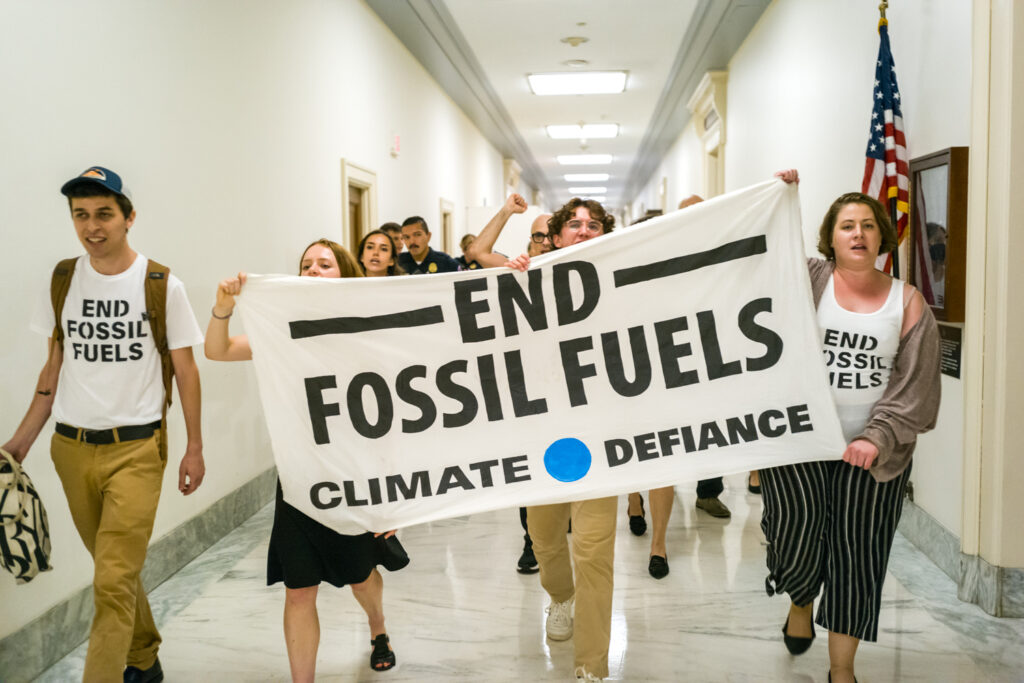 Climate Defiance marches through the halls of the Rayburn congressional office building in Washington, D.C. in July 2023. Credit: Courtesy of Climate Defiance
