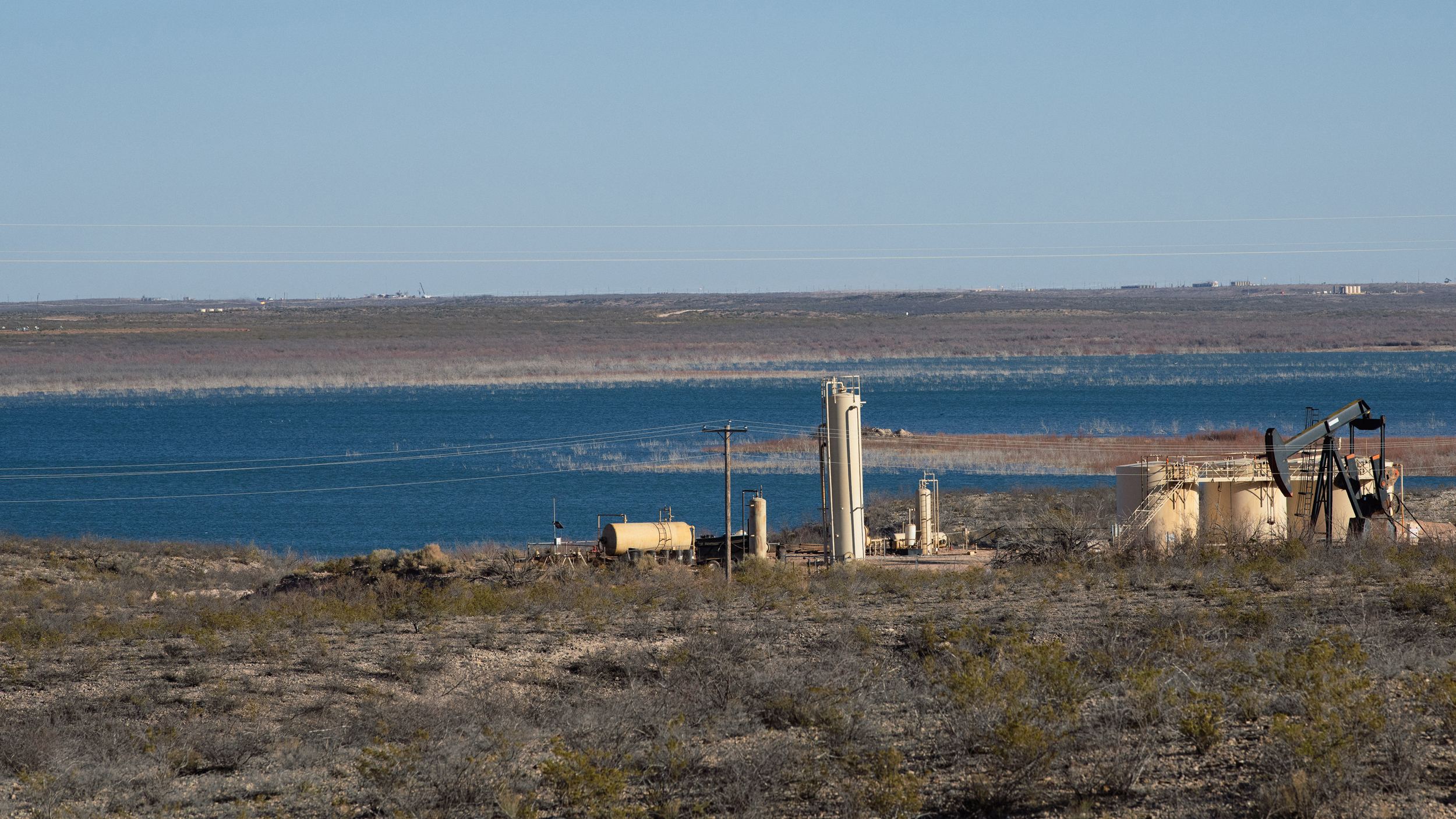 An oil drilling operation on the banks of the Red Bluff Reservoir in Reeves County, Texas on May 27, 2020. Credit: Justin Hamel