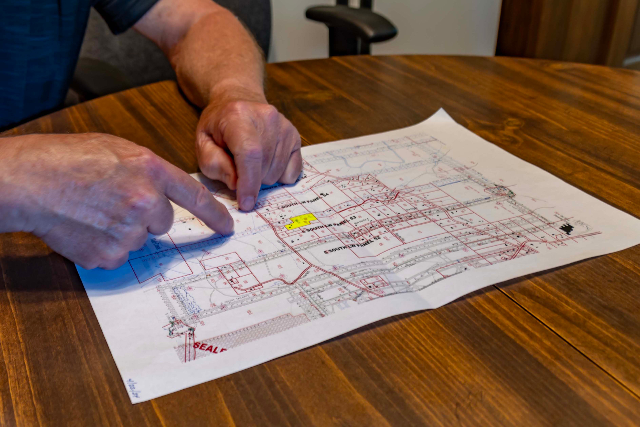 A Riley family member points to their property on a mining map. Credit: Lee Hedgepeth/Inside Climate News